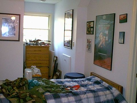 1988 Ford Bronco - A cluttered bedroom scene with a bed, dresser, and various items on display.