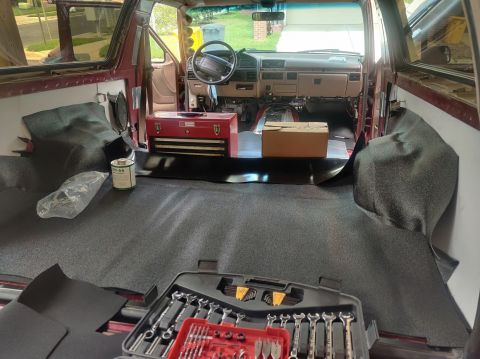 1996 Ford Bronco - 20200821 - Needed heavy boxes to keep the MLV down on the bit that attached the cargo area to the cabin area while the vinyl cement set.