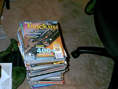 1988 Ford Bronco - A pile of truck enthusiast magazines sits on the floor next to an office chair.