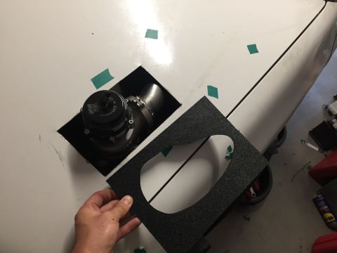 1993 Mercury Tracer - A person is installing a blow-off valve on a white car hood, with a gasket in hand.