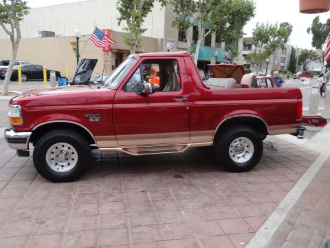 1994 Ford Bronco - This 1994 Ford Bronco is parked on a tiled surface with its hood open.