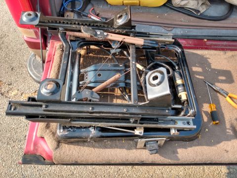 1994 Ford Bronco - The internal workings of a vehicle seat are exposed after removal from the car.