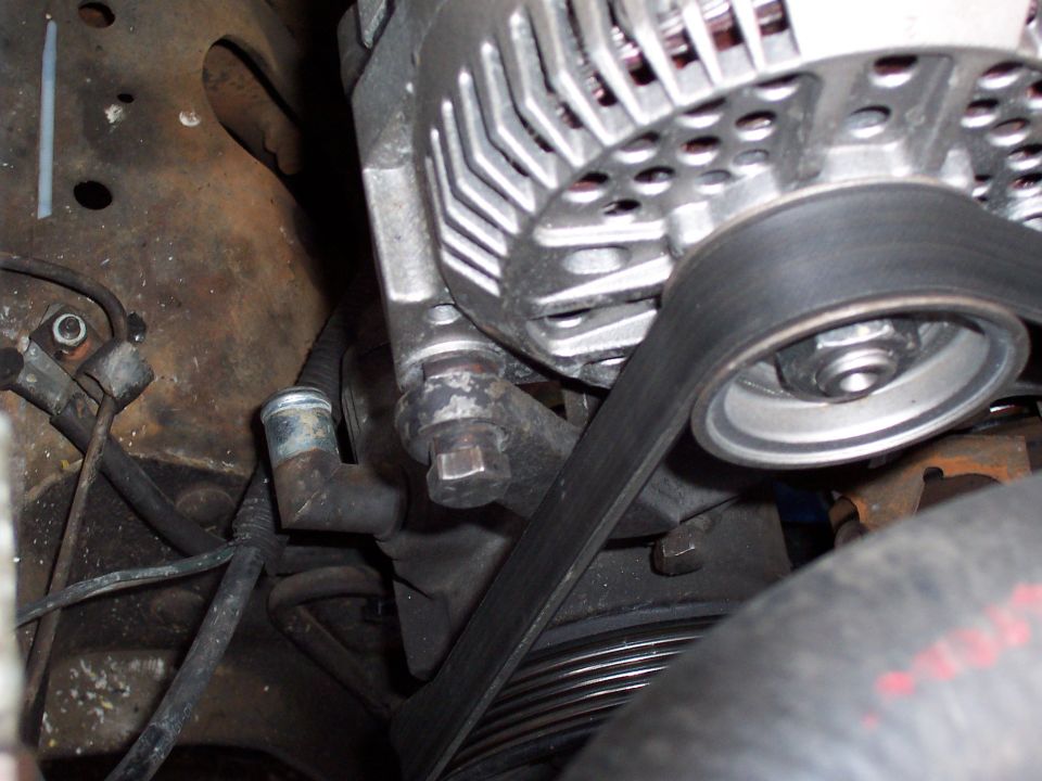 Engine bay close-up of alternator, serpentine belt, and pulleys on a Ford Bronco