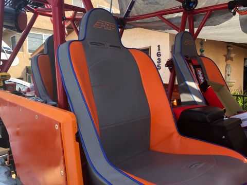 1992 Jeep Wrangler - The interior features custom orange and gray PRP seats with a roll cage structure visible.