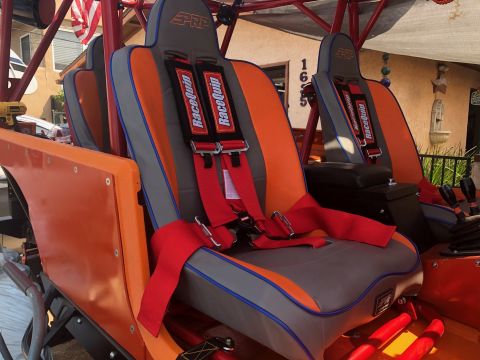 1992 Jeep Wrangler - Custom racing seats with PRP branding and red RaceQuip harnesses are visible inside an off-road vehicle.