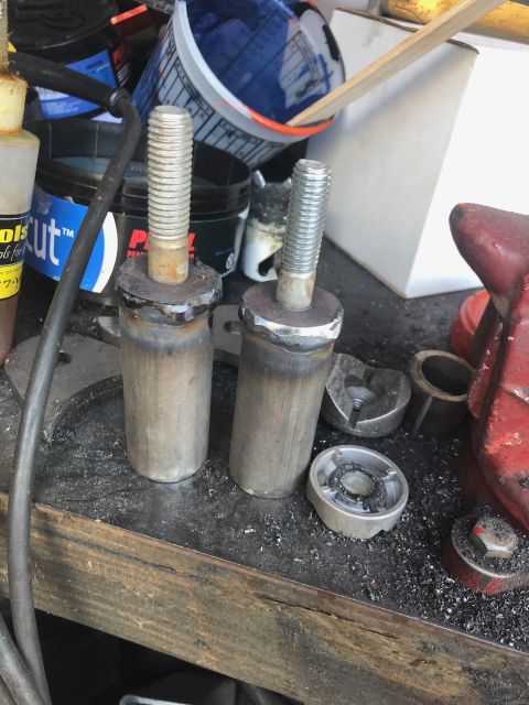 1992 Jeep Wrangler - These custom-fabricated metal parts with threaded bolts are shown on a workbench, surrounded by metal shavings and tools.