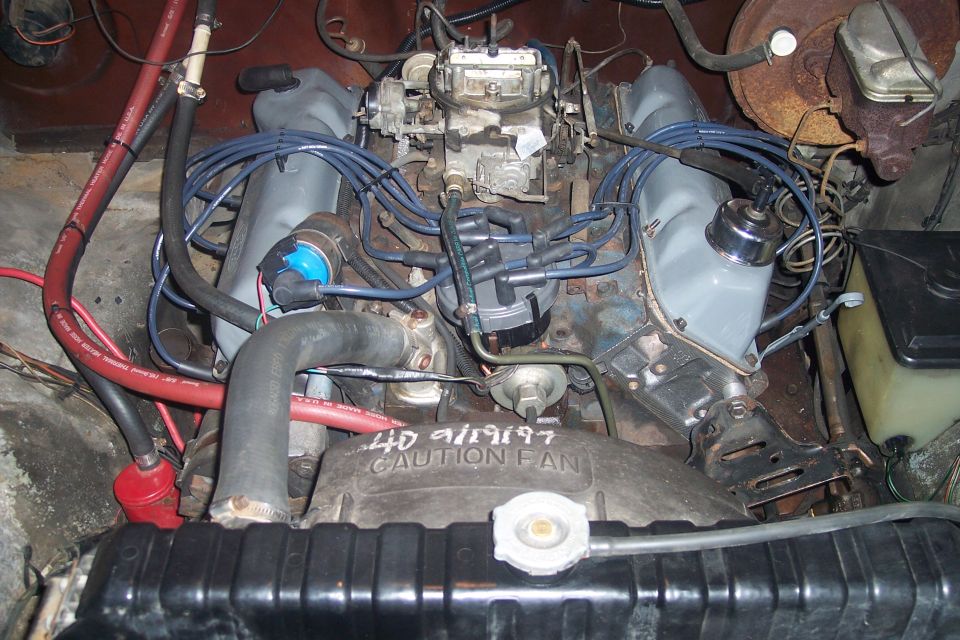 Engine bay with V8 engine, carburetor, distributor, and radiator