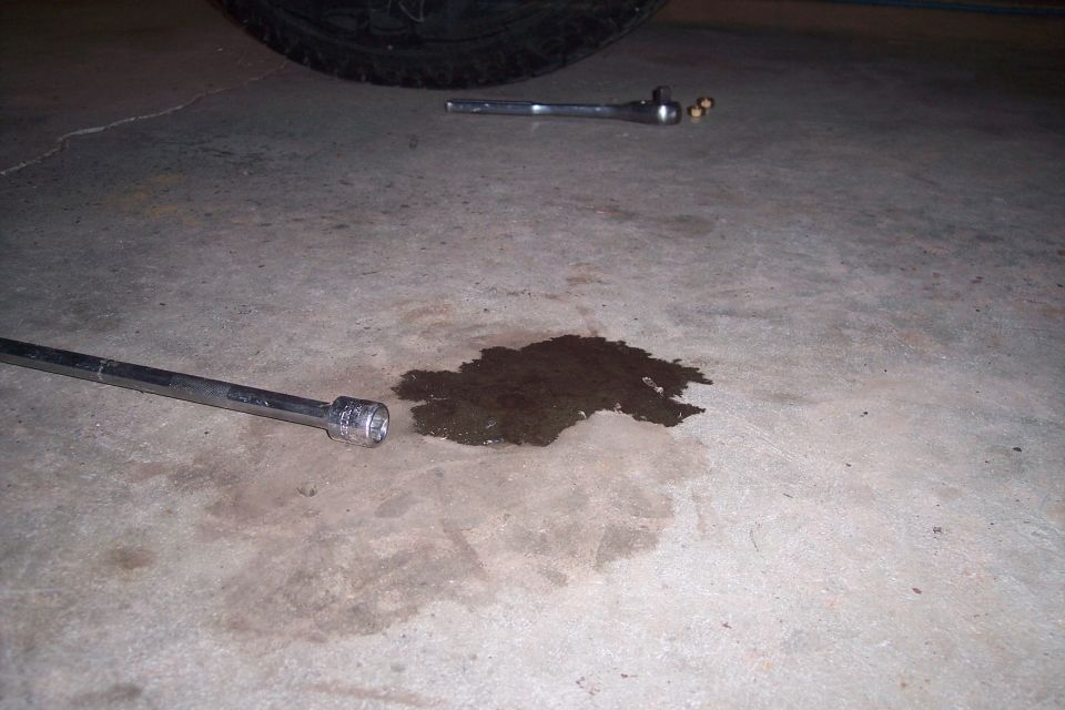 Oil stain on concrete with socket wrench and ratchet