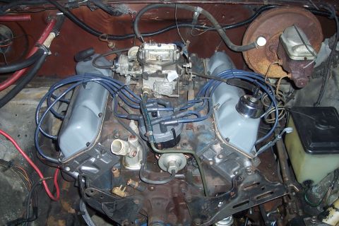 1978 Ford Bronco - Close-up view of a V8 engine, showing the carburetor, distributor, and brake booster assembly.