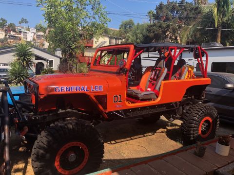 1992 Jeep Wrangler - This modified Jeep Wrangler features "GENERAL LEE" and "01" graphics, a prominent roll cage, and racing seats, suggesting a custom build ra…