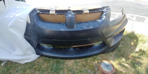 1996 Ford Bronco - Front bumper cover, possibly for a Pontiac G8, is shown outdoors.