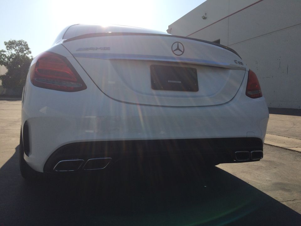 Rear view of a white 2017 Mercedes-Benz C63 AMG with quad exhaust tips