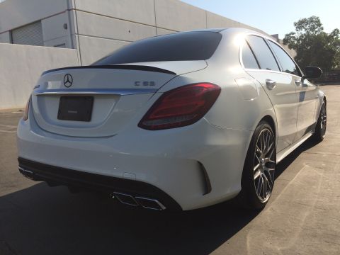 2017 Mercedes-Benz C-Class - Rear view of a white 2017 Mercedes-Benz C63 sedan parked outdoors.