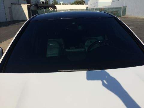 2017 Mercedes-Benz C-Class - The interior of a white car with a black roof is visible through the windshield, revealing the seats and steering wheel.