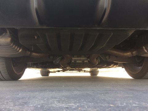 2017 Mercedes-Benz C-Class - Underside view of a car's exhaust and suspension system, with tires visible.