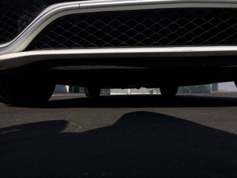2017 Mercedes-Benz C-Class - The underside of a car is visible, along with its front grille and part of a tire.