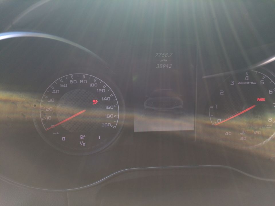 Dashboard gauges showing speed, RPM, fuel level, and mileage. A small car graphic is displayed