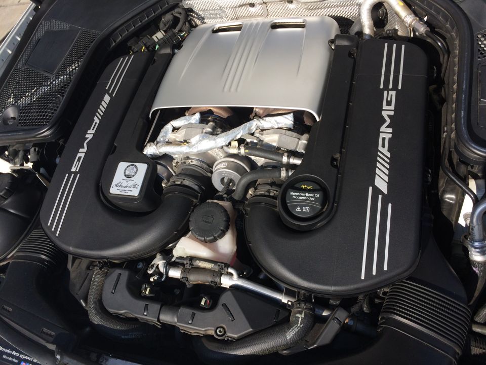 Close-up of a Mercedes-AMG engine with "AMG" branding on the black covers
