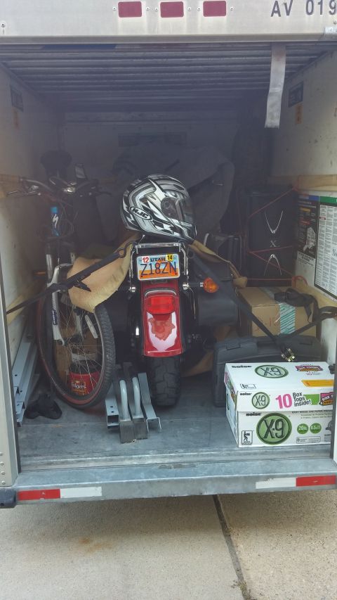 1996 Ford Bronco - Motorcycle and bicycle packed inside a trailer with other items.