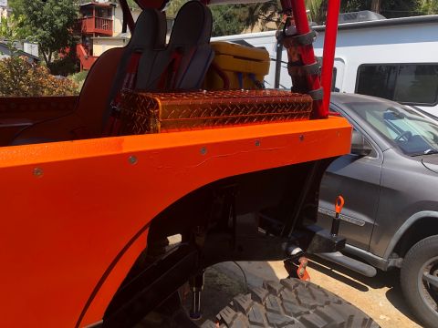 1992 Jeep Wrangler - The rear section of an orange off-road vehicle is shown, with a toolbox and racing seats visible.