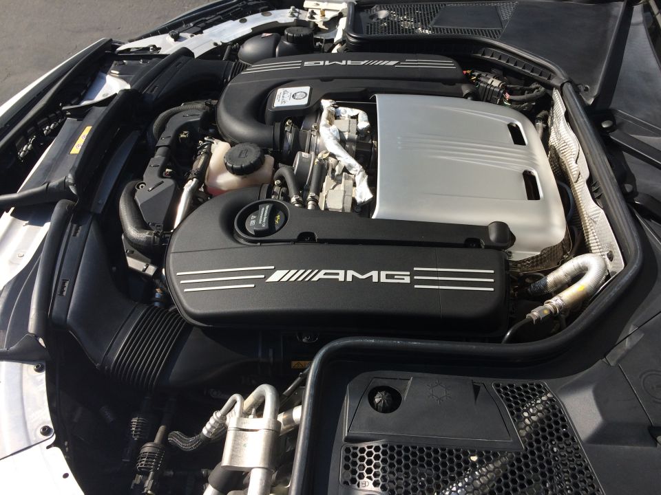 Engine bay with AMG branding on covers. Supermotors.net watermark visible