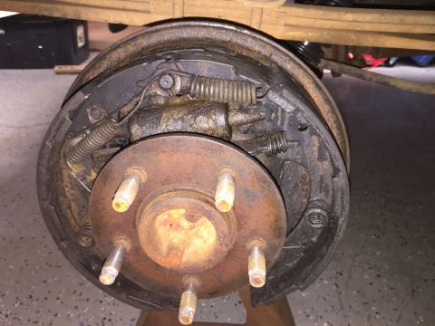 1998 Ford Ranger - A close-up view of a worn drum brake assembly, revealing its internal components and rust.