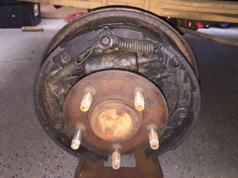 1998 Ford Ranger - Close-up view of a vehicle's drum brake assembly, showing internal components and a five-lug hub.