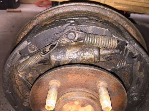 1998 Ford Ranger - Drum brake assembly showing wear and tear on the brake shoes and springs.