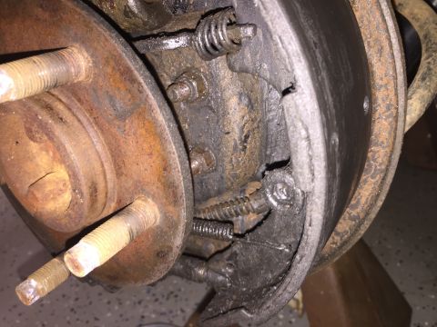 1998 Ford Ranger - This is a close-up view of a vehicle's brake drum assembly, showing worn brake shoes and springs.
