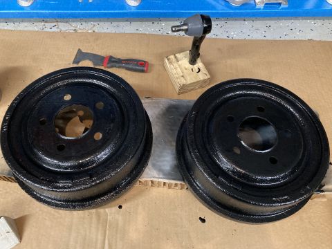 1998 Ford Ranger - Two freshly painted brake drums are ready for installation, alongside tools used for preparation.