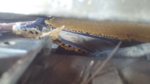 1996 Ford Bronco - Torn cardboard and debris are visible in this close-up shot, obscuring the main subject.