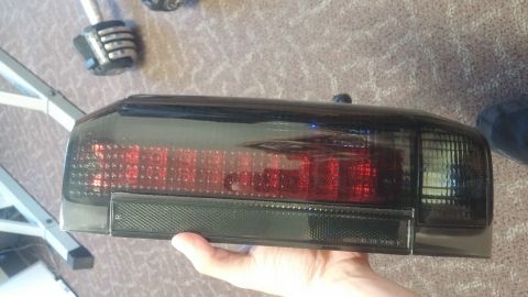 1996 Ford Bronco - Aftermarket tail light assembly, likely for a truck or SUV, held for inspection.