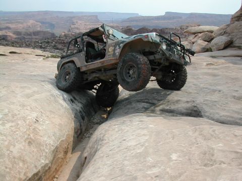 1992 Jeep Wrangler - A 1992 Jeep Wrangler tackles a challenging rocky terrain, demonstrating its off-road capabilities.