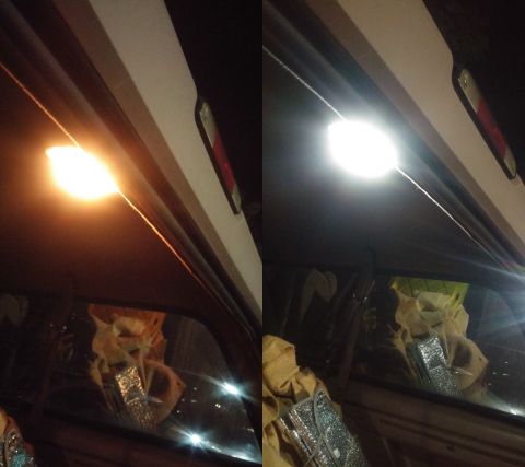 1996 Ford Bronco - The interior of a vehicle is illuminated by an overhead light, with a sunshade visible in the window's reflection.
