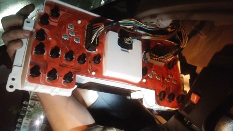1996 Ford Bronco - A car's instrument cluster is removed, revealing its internal wiring and circuit board.