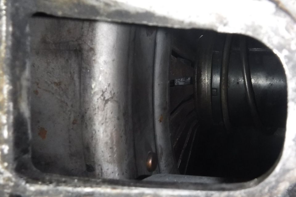 Still can't get clutch to disengage...  Best pic I could get of the throwout bearing and pressure plate in their relaxed state.  Bearing travel with the pedal pressed looks close to spec, but I haven't tried getting an exact measurement yet.  Had hoped to see in between the PP fingers with a borescope, to see if FLYWHEEL SIDE marking faces rearward (i.e., installed backward), but couldn't get a view of anything.