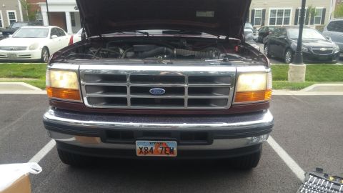 1996 Ford Bronco - Front view of a red 1996 Ford Bronco with its hood open, revealing the engine compartment.