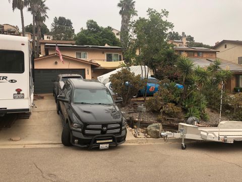 1992 Jeep Wrangler - Black Ram pickup truck and RV parked in a residential driveway.