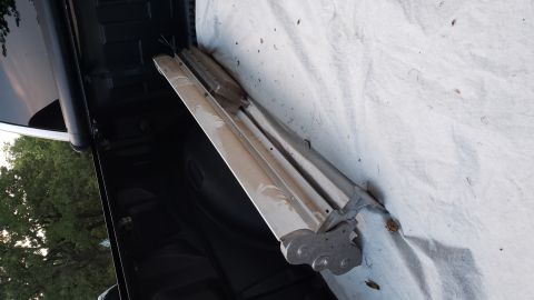 1965 Ford Mustang - Chrome trim piece with mounting hardware, placed on a white tarp.
