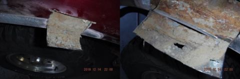 1996 Ford Bronco - Close-up view of a rusted metal panel on a red vehicle, obscuring the wheel well.