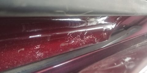 1996 Ford Bronco - Rust damage is visible on the lower body panel of a vehicle.