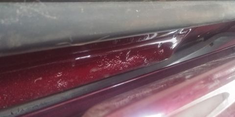 1996 Ford Bronco - The paint on this vehicle's door jamb shows signs of bubbling, indicating potential rust or damage.