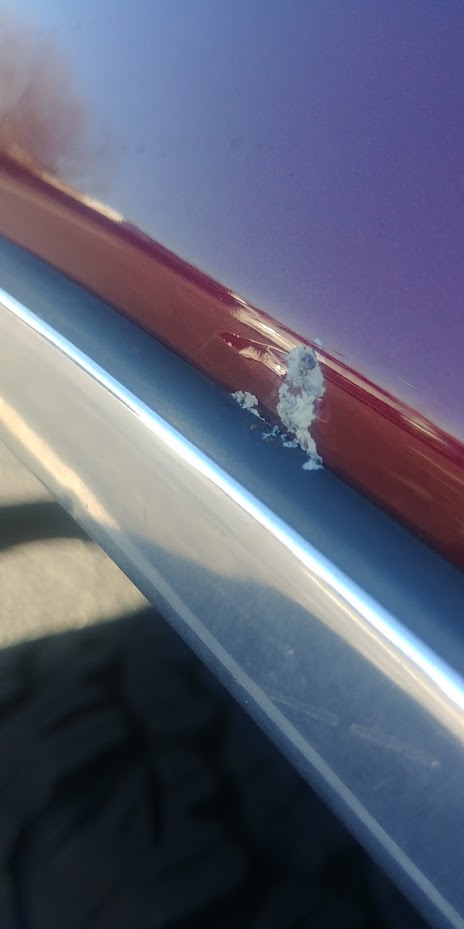 1996 Ford Bronco - Paint damage is visible on the body trim of this vehicle.
