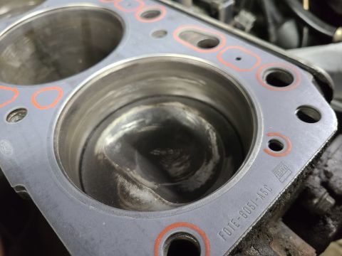 1995 Ford F-150 - I found a NOS Ford head gasket, which is made by Fel-Pro. Note the oval at the left center of the pic. IF THE IMAGE IS TOO SMALL, click it.…