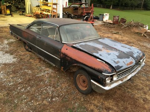 1961 Ford Starliner - This 1961 Ford Starliner is in rough condition, showing significant rust and primer on its front end.