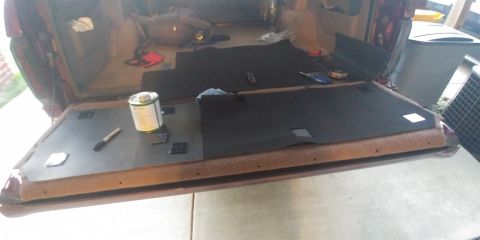 1996 Ford Bronco - Carpet installation in progress inside a vehicle's cargo area.