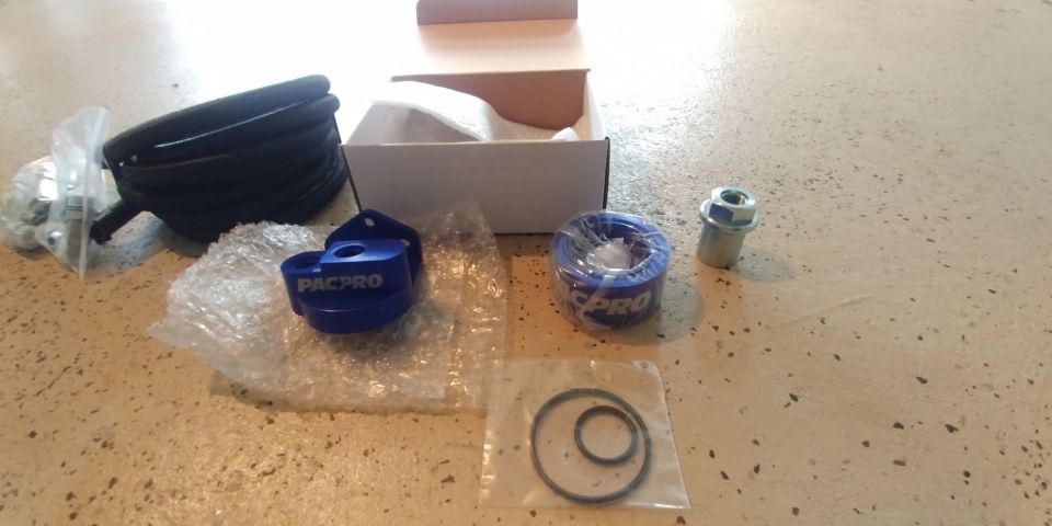 Blue PACPRO oil filter adapter with black hose and hardware