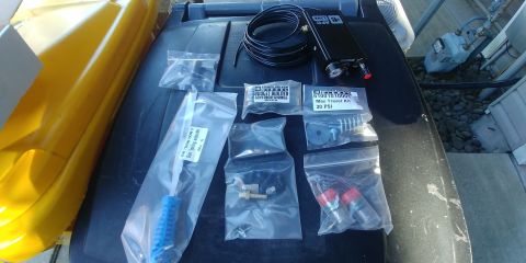 1996 Ford Bronco - Various air suspension components and tools are displayed on a surface, including a Max Travel Kit.