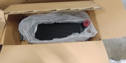 1996 Ford Bronco - A new intercooler is shown inside its shipping box, ready for installation.