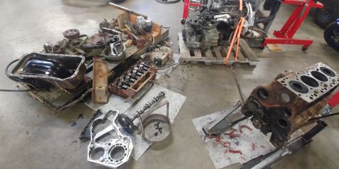 1996 Ford Bronco - Engine components are spread out on the floor, suggesting a repair or rebuild process.